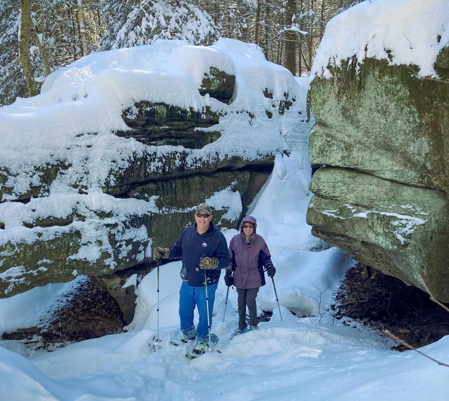 Two people using snowshoes in a nearby national park.
