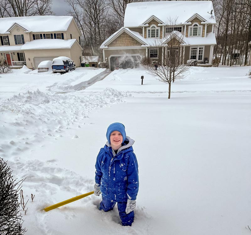 A boy playing in the snow.