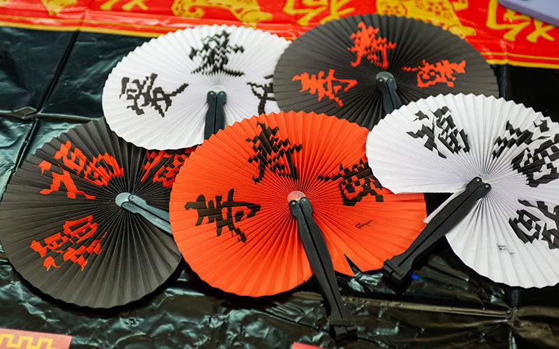 Decorative fans on a table.