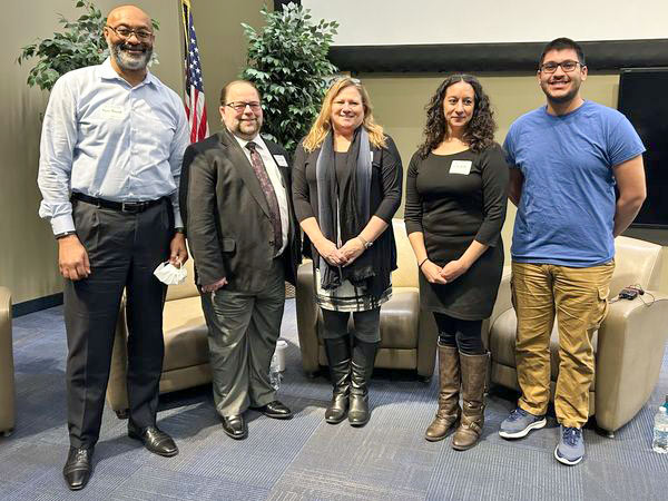 Five panelist stand in a row.