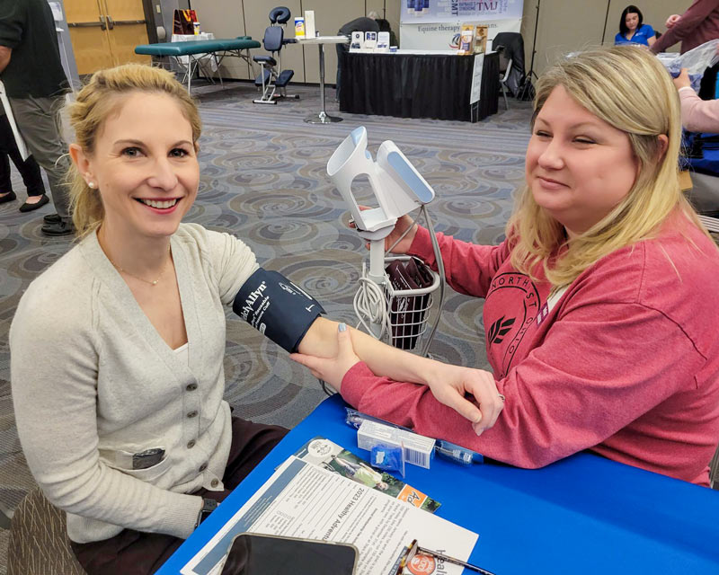 A woman gets her blood pressure measured.