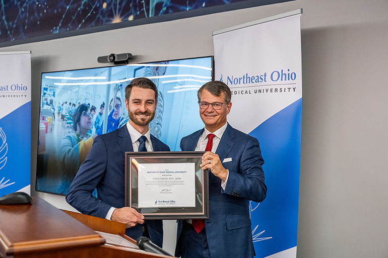 Jordan Cinderich accepts an award from Dr. John Langell