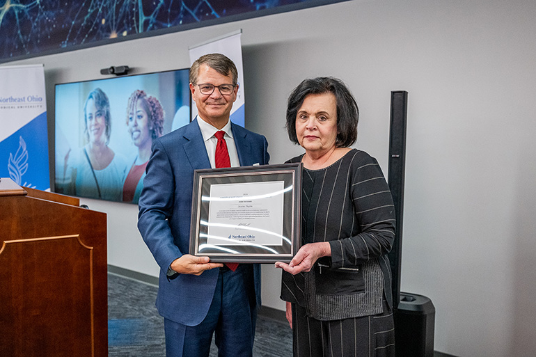 Dr. John Langell presents an award to Joann Hayes