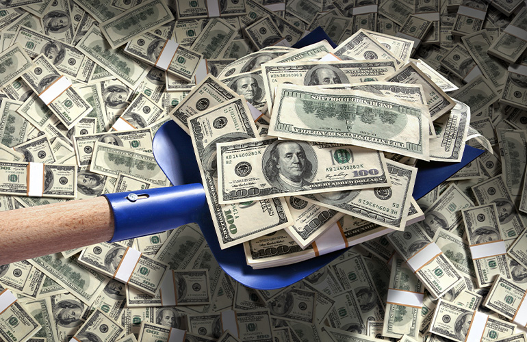 A shovel scooping up $100 bills