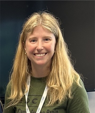 Blond woman in crewneck top smiles for the camera