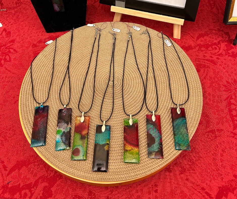 Several pendant necklaces on a circular display board