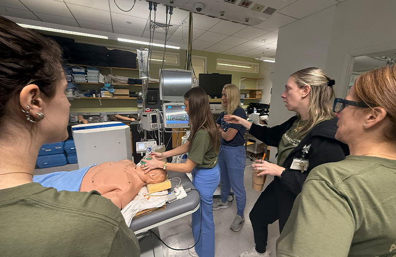 Students practice managing an airway with a training mannequin