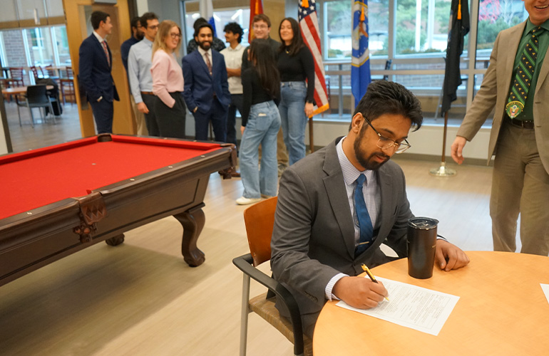 Prateek Asthana signing his military commission