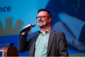 Photo of Nick Pinkerton with microphone