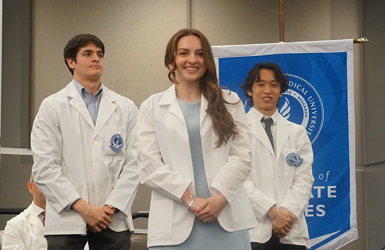 Student graduate smiling after putting on white coat
