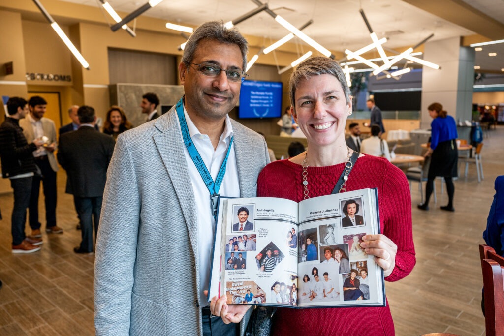Anil Jagetia and Sonum Jagetia pose with a copy of Anil's NEOMED yearbook