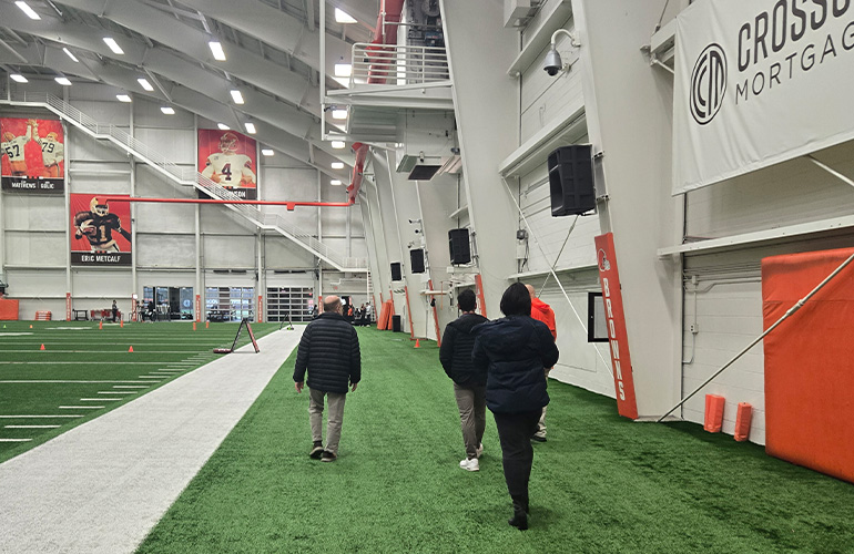 A group of people tour an athletic training facility