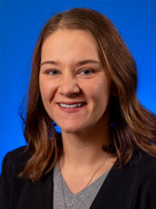 Headshot of Jessica Emshoff on a blue background
