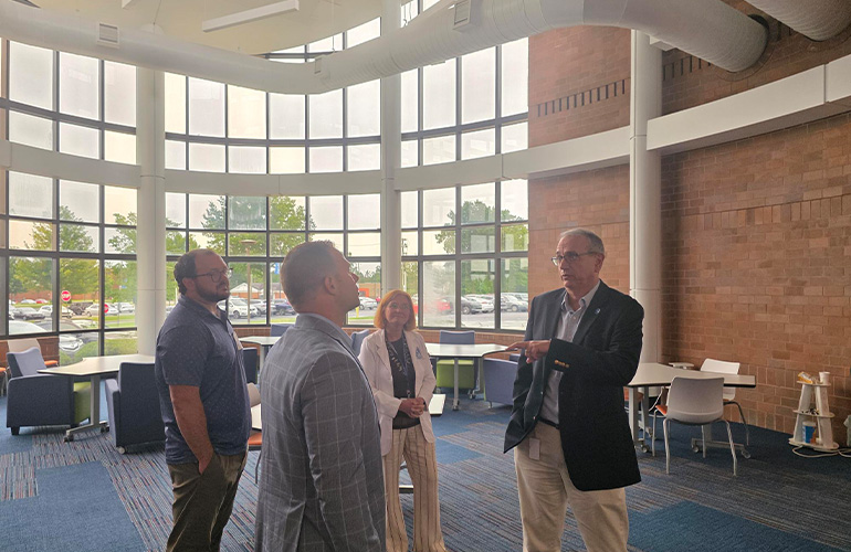 Dentistry dean Sorin Teich shares information to a small group in the Bitonte Atrium at NEOMED