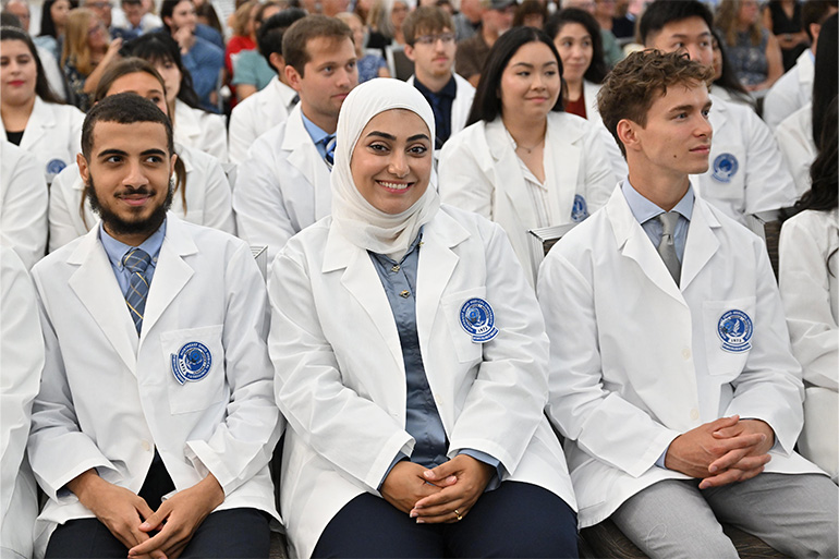 NEOMED Bitonte College of Dentistry students smiling at the 2026 White Coat Ceremony