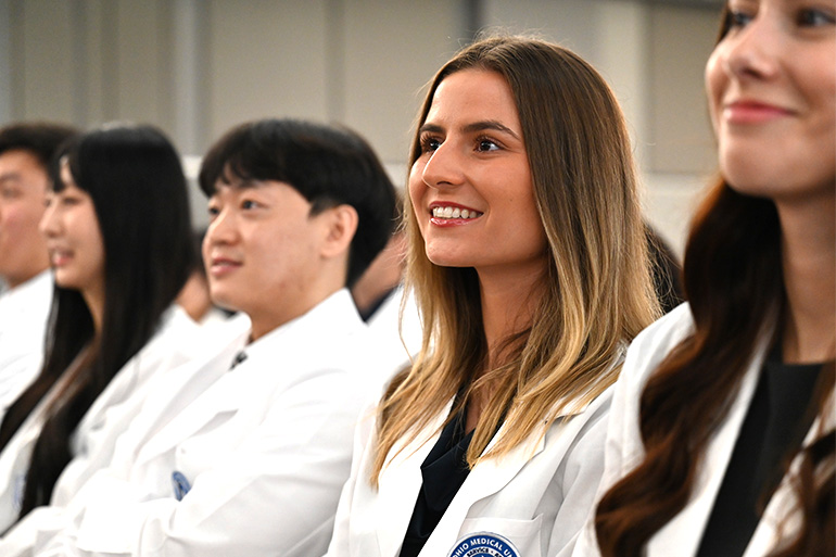 NEOMED Bitonte College of Dentistry students smiling at the 2026 White Coat Ceremony