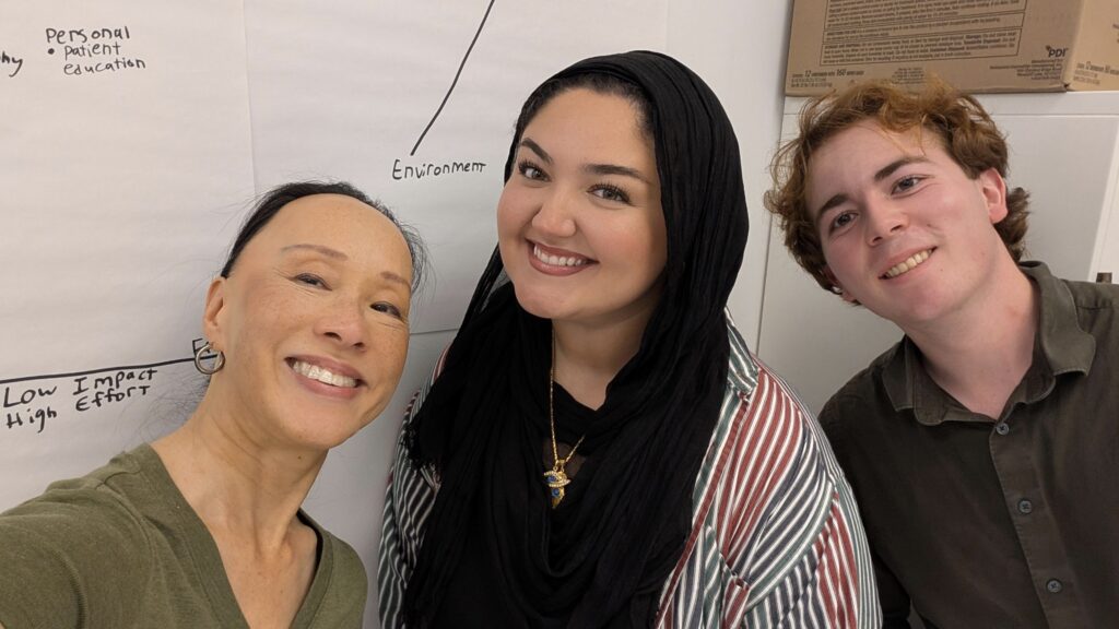 three people pose for a selfie