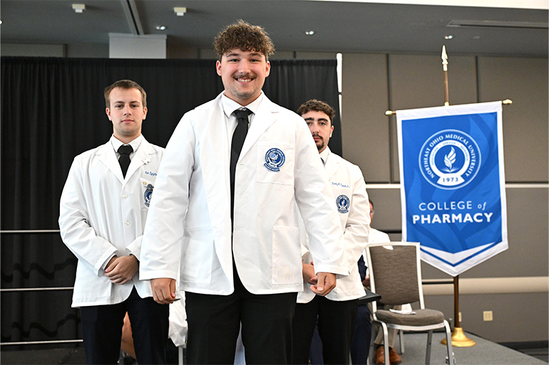 NEOMED College of Pharmacy student smiling at the 2026 Pharmacy White Coat Ceremony