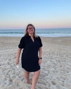 Woman in a blue dress walks on the beach
