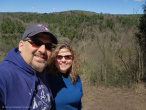 A man and woman take a selfie in the wilderness