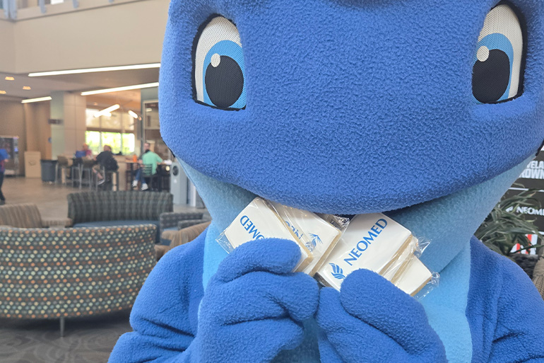 Nate the Walking Whale munches on some NEOMED branded cookies